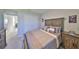 This bedroom features carpet flooring, a large bed, and a spacious closet for ample storage at 1407 Tropical Oasis Ave, Plant City, FL 33565
