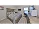 Comfortable bedroom offering a large bed, lake views, and modern entertainment with a TV and gaming console at 1407 Tropical Oasis Ave, Plant City, FL 33565