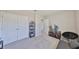 This bedroom features carpet, a closet, unique decor and black chair for a combination of relaxation and storage at 1407 Tropical Oasis Ave, Plant City, FL 33565