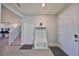 Inviting entryway with white storage bench and hooks, tiled flooring, and neutral color palette at 1407 Tropical Oasis Ave, Plant City, FL 33565