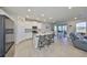 Spacious kitchen features a large island, modern appliances, and an adjacent dining area at 1407 Tropical Oasis Ave, Plant City, FL 33565