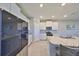 Bright kitchen featuring white cabinetry, granite countertops, stainless steel appliances, and a center island at 1407 Tropical Oasis Ave, Plant City, FL 33565
