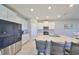 Bright kitchen featuring white cabinetry, granite countertops, stainless steel appliances, and a center island at 1407 Tropical Oasis Ave, Plant City, FL 33565