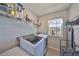 Functional laundry room equipped with modern washer and dryer, ample shelf storage and a window at 1407 Tropical Oasis Ave, Plant City, FL 33565