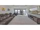 Spacious living area with plush reclining seats, carpet, and a big screen television at 1407 Tropical Oasis Ave, Plant City, FL 33565