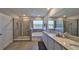 Bright bathroom with double sinks, a large mirror, tiled shower and separate tub at 1407 Tropical Oasis Ave, Plant City, FL 33565
