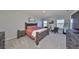 Stylish main bedroom suite with water views, a sitting area, and neutral carpet at 1407 Tropical Oasis Ave, Plant City, FL 33565