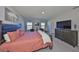 Light-filled main bedroom with water view, a sitting area, and stylish furnishings at 1407 Tropical Oasis Ave, Plant City, FL 33565