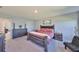 Main bedroom suite with neutral colored walls, carpet, and stylish furnishings at 1407 Tropical Oasis Ave, Plant City, FL 33565