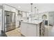 Bright kitchen with stainless steel appliances, a center island, and modern white cabinets at 14834 Crown Dr, Largo, FL 33774