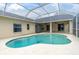 View of the screened-in pool area with a uniquely shaped pool and covered patio at 1521 Ledgestone Dr, Brandon, FL 33511