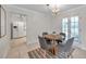 Dining room with chandelier, view to backyard and open to adjacent kitchen at 1707 Sunnyhills Dr, Brandon, FL 33510