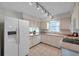 Well-lit kitchen with a view, showcasing modern appliances and white cabinetry at 1707 Sunnyhills Dr, Brandon, FL 33510