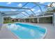 Outdoor pool under screen enclosure with seating area at 1707 Sunnyhills Dr, Brandon, FL 33510