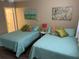 Bedroom featuring two beds, a ceiling fan, and comfortable decor at 17580 Gulf Blvd # 302, Redington Shores, FL 33708