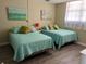 Bright and airy bedroom with two twin beds, cozy quilts, and comfortable decor at 17580 Gulf Blvd # 302, Redington Shores, FL 33708