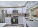 Updated kitchen featuring stainless steel appliances, white cabinets, and a decorative backsplash at 17580 Gulf Blvd # 302, Redington Shores, FL 33708