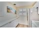 Bright kitchen with a stainless steel refrigerator, white cabinets, and modern countertops at 17580 Gulf Blvd # 302, Redington Shores, FL 33708