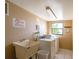 Functional laundry room with washer, dryer, and sink for convenience at 17580 Gulf Blvd # 302, Redington Shores, FL 33708