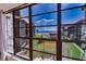 Expansive living room view featuring a pool, lush green lawn, and the beautiful ocean at 17580 Gulf Blvd # 302, Redington Shores, FL 33708