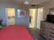 Cozy main bedroom featuring a walk-in closet, ensuite bathroom, and wood-look floors at 17580 Gulf Blvd # 302, Redington Shores, FL 33708
