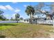 Large fenced backyard with green grass and trees at 2003 6Th Sw Pl, Largo, FL 33770