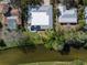 Aerial view of property featuring solar panels, lush greenery, and waterfront access at 2215 River Ridge Dr, Sarasota, FL 34239