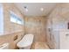 Bright bathroom showcasing a standalone tub, neutral stone tiling, and a window for lots of natural light at 2215 River Ridge Dr, Sarasota, FL 34239