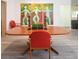 Dining room featuring modern art, wood-look flooring, and a wooden table with red chairs at 2215 River Ridge Dr, Sarasota, FL 34239