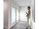 Bright hallway featuring wood-look floors, fresh paint, and a Buddha statue at 2215 River Ridge Dr, Sarasota, FL 34239