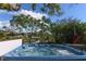 Scenic view of a hot tub overlooking a tranquil canal with lush vegetation at 2215 River Ridge Dr, Sarasota, FL 34239
