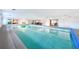 Large indoor swimming pool with lounge areas, offering a private and recreational space within the home at 2215 River Ridge Dr, Sarasota, FL 34239