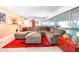 Plush living room featuring a large sectional and an indoor swimming pool at 2215 River Ridge Dr, Sarasota, FL 34239