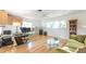 Bright office with light wood floors, a glass desk, a sitting area, and lots of natural light at 2215 River Ridge Dr, Sarasota, FL 34239