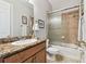 Bathroom featuring a granite countertop, a shower with a glass door, and tile flooring at 2307 Victoria Gardens Ln, Tampa, FL 33609