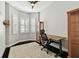 Home office with a gray geometric rug, a wood desk and plenty of natural light at 2307 Victoria Gardens Ln, Tampa, FL 33609