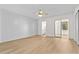Bright bedroom featuring wood floors, accent wall, and bathroom access at 2404 Florentine Way # 40, Clearwater, FL 33763