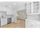 Modern kitchen with white cabinets, stainless steel appliances, and quartz countertops at 2404 Florentine Way # 40, Clearwater, FL 33763