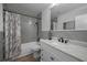 Updated bathroom featuring a shower and tub combo, modern sink, and vanity with a granite countertop at 2430 Florentine Way # 44, Clearwater, FL 33763