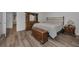 Bedroom featuring hardwood floors, dresser, nightstand, and decorative wood storage chest at 2430 Florentine Way # 44, Clearwater, FL 33763