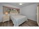Bright bedroom showcasing wood floors, a ceiling fan, and a decorative white headboard at 2430 Florentine Way # 44, Clearwater, FL 33763
