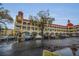 Multi-story apartment building with a clock tower, parking, and arched walkways at 2430 Florentine Way # 44, Clearwater, FL 33763