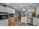Open kitchen with stainless steel appliances, white cabinets, and views into the living area at 2430 Florentine Way # 44, Clearwater, FL 33763