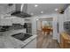Well-lit kitchen featuring white cabinets, granite countertops, stainless steel appliances, and an adjacent dining area at 2430 Florentine Way # 44, Clearwater, FL 33763