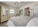 Bedroom featuring a mirror wardrobe and decorative chair for added charm at 2800 E Vina Del Mar Blvd, St Pete Beach, FL 33706