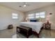 Bedroom with large windows, ceiling fan, and bench at the foot of the bed at 2800 E Vina Del Mar Blvd, St Pete Beach, FL 33706