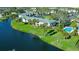 Overhead view of the pond-adjacent property, showcasing the pool, manicured landscaping and parking area at 3001 58Th S Ave # 312, St Petersburg, FL 33712