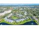 Aerial view of the neighborhood showcasing lush landscaping, a pond, a pool and proximity to the ocean at 3001 58Th S Ave # 312, St Petersburg, FL 33712