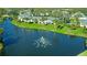 Community aerial view showing the pond with a fountain, swimming pool, and manicured landscaping at 3001 58Th S Ave # 312, St Petersburg, FL 33712