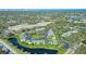 Aerial view of condo community featuring lush landscaping, a pool, and a beautiful pond at 3001 58Th S Ave # 312, St Petersburg, FL 33712